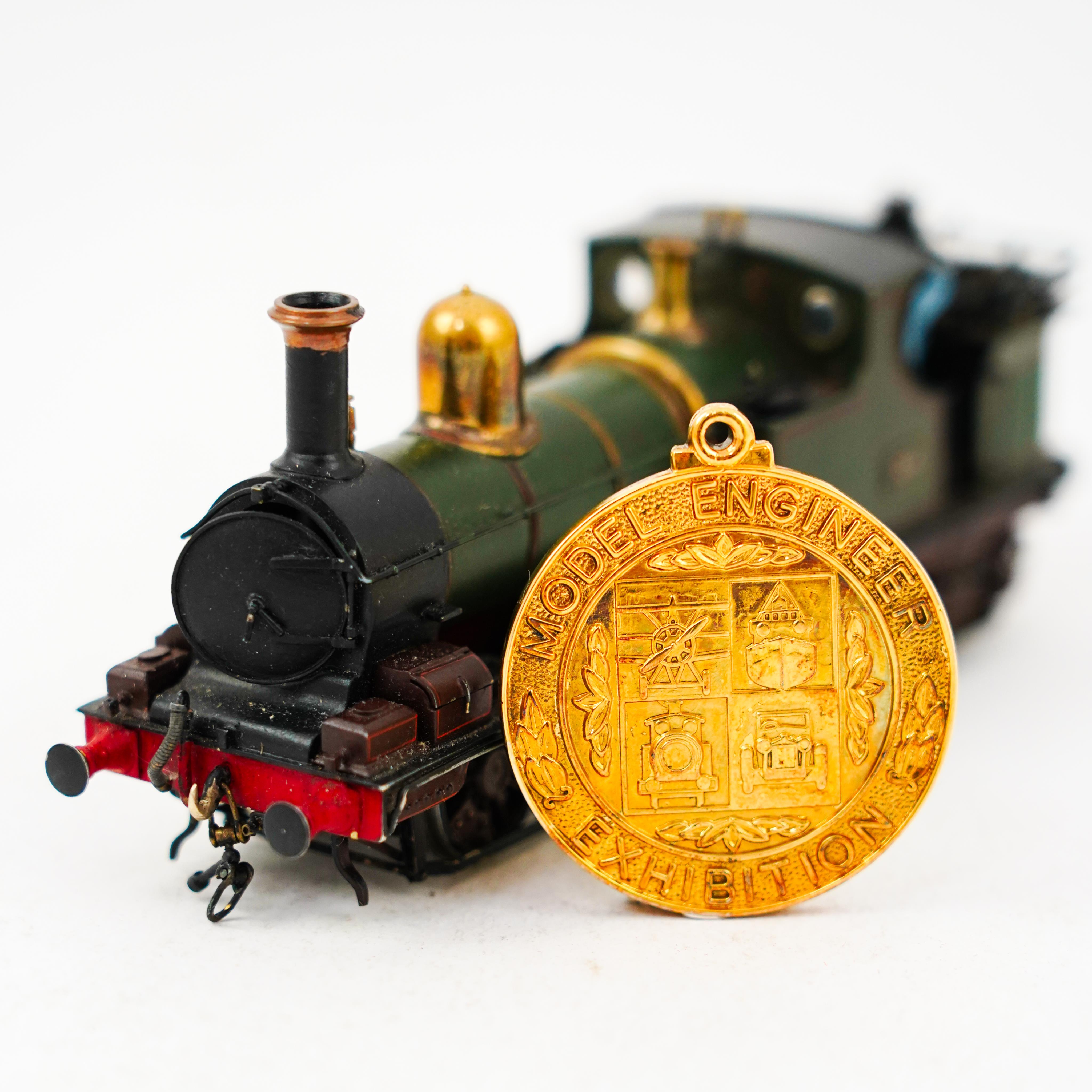 An award winning EM gauge scratch built model railway locomotive by John Worsley, GWR Dean 0-4-4T, 34, rebuilt for the Woolmer Instructional Military Railway (later the Longmoor Military Railway), together with the medal
